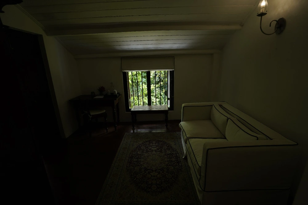Interior of India Admiral bedroom, showcasing a couch beside a window with a view.