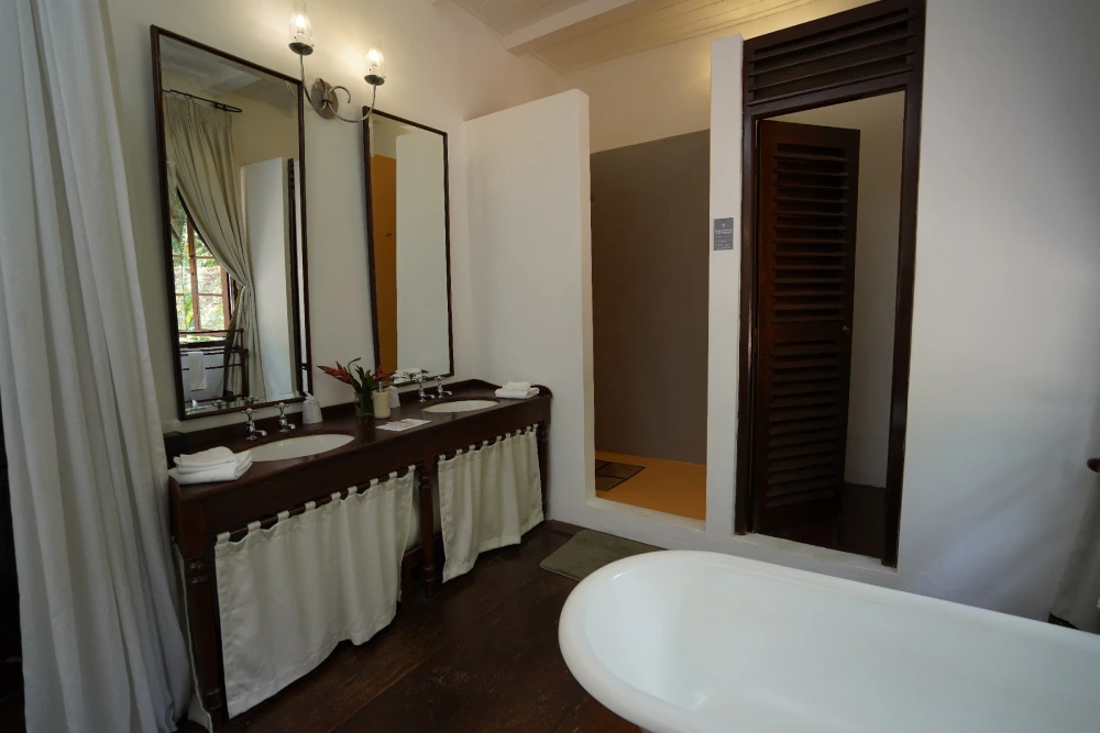 Elegant bathroom in sunbeam room, featuring a bathtub and sink, bathed in warm sunlight for a serene atmosphere.