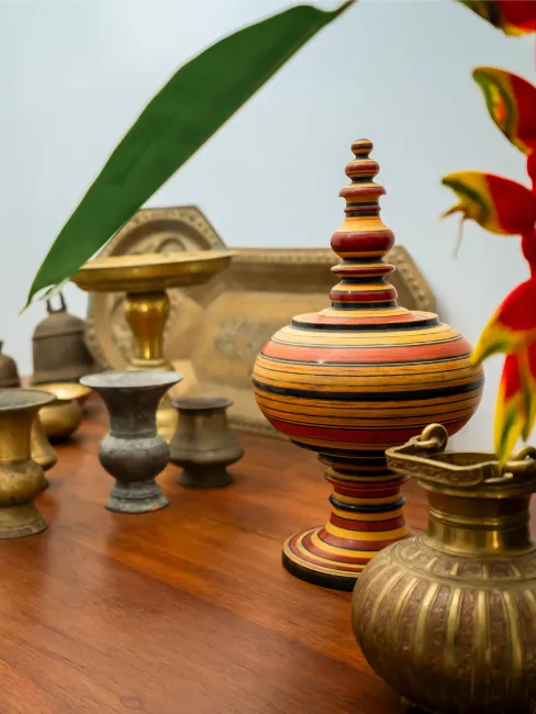 Curated collection of traditional Sri Lankan artefacts and handcrafted décor displayed within the heritage interiors of Adigar’s Manor